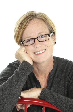 A portrait of a woman wearing glasses in front of a white background for Prevent Blindness