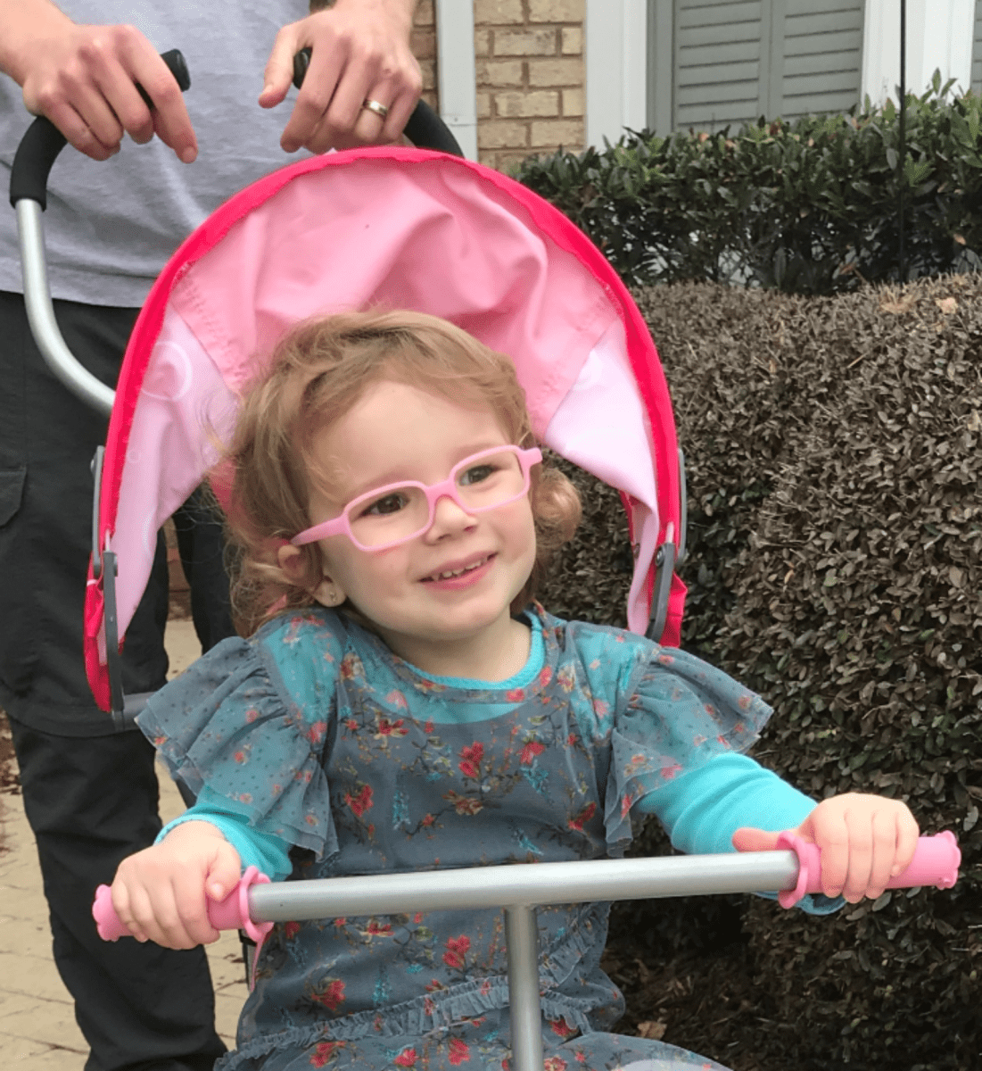 A photo of a small child named Charlotte with glasses