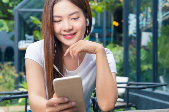 a young woman reading from her smart phone