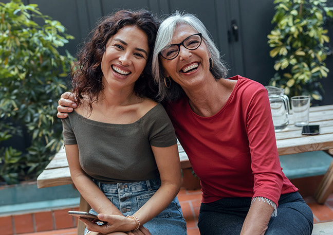 a mother wearing glasses and her adult daughter