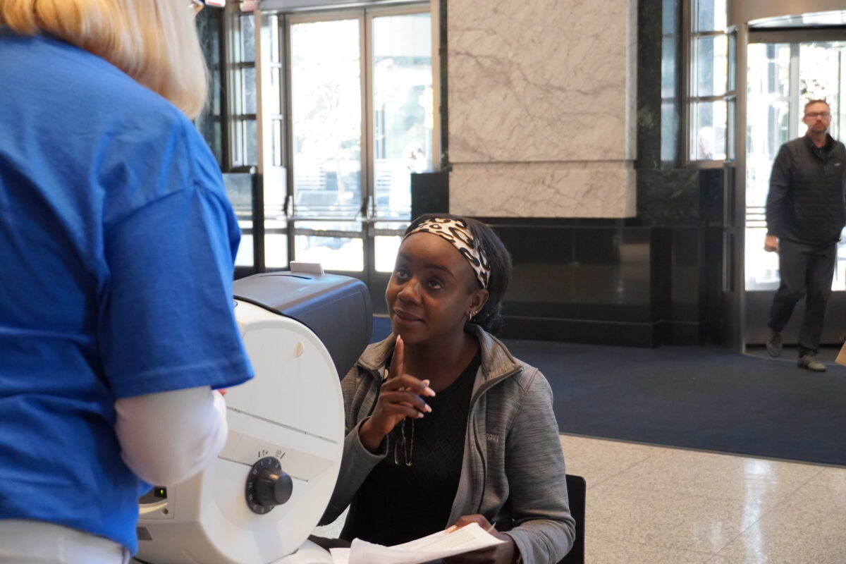 A vision screening participant asks a question.