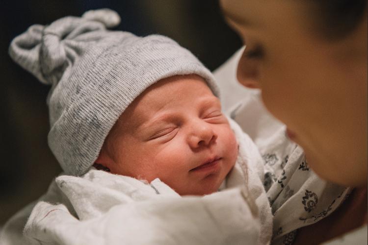 a newborn baby in the hospital with its mother
