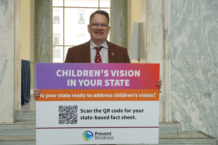 Rep. Gus Bilirakis of Florida holds a sign about children's vision. Rep. Gus Bilirakis of Florida holds a sign about children's vision.