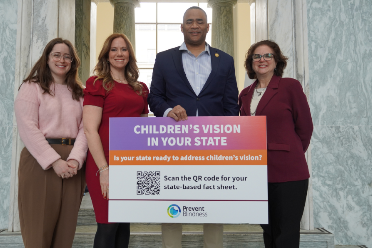 Rep. Marc Veasey of Texas holds a sign about childcare's vision; with Prevent Blindness staff. Rep. Marc Veasey of Texas holds a sign about childcare's vision; with Prevent Blindness staff.