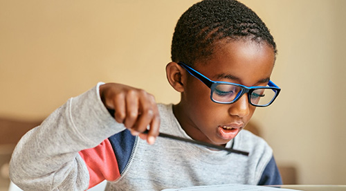 a child at school wearing glasses