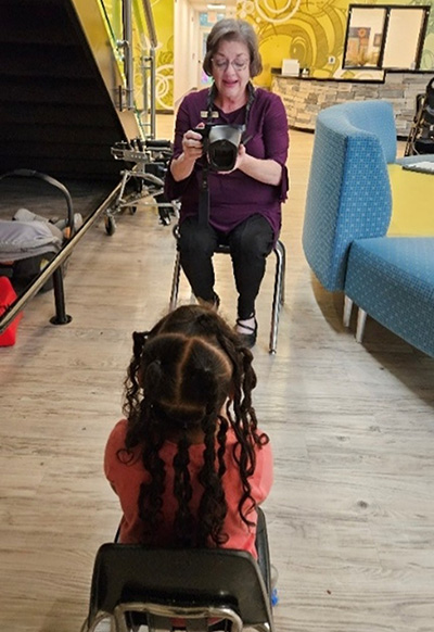 A woman conducting a vision screening with a child